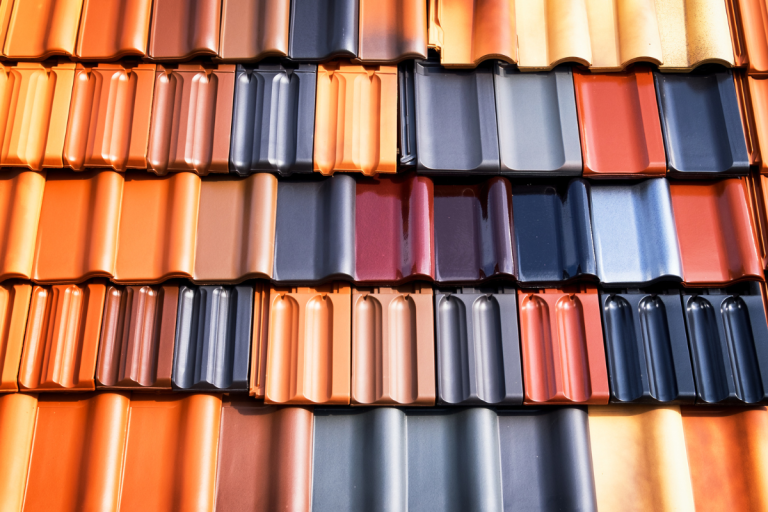 A vibrant array of colorful roof tiles showcasing various hues, representing Mr. Max Roofing's commercial roof replacement services.
